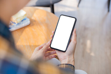 cell phone blank white screen mockup.woman hand holding texting using mobile on desk at office.background empty space for advertise.work people contact marketing business,technology