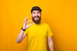 © Vulp - A young bearded man is holding excited a bitcoin looking at the camera .