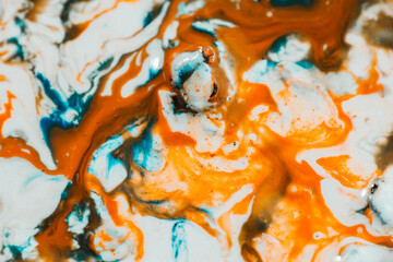 Wall Mural - Luqiud vivid blue and orange color mixing together on white background. Painting, splash marble abstract texture