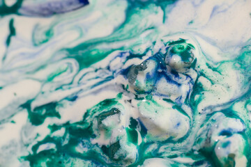 Wall Mural - Luqiud vivid blue and green color mixing together on white background. Painting, splash marble abstract texture