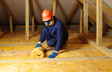 Fototapeta Sport - Worker insulate the attic with mineral wool