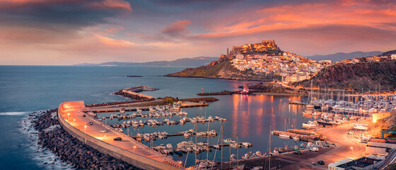 Wall Mural - Сharm of the ancient cities of Europe. Panoramic evening cityscape of Castelsardo port. Stunning sunset on Sardinia island, Province of Sassari, Italy, Europe. Mediterranean seascape.