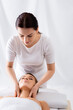 © LIGHTFIELD STUDIOS - masseur doing neck massage to client with closed eyes in spa salon