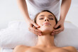 © LIGHTFIELD STUDIOS - female masseur doing facial massage to client in spa salon