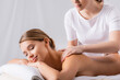 © LIGHTFIELD STUDIOS - female masseur massaging pleased client lying on massage table