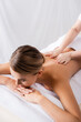 © LIGHTFIELD STUDIOS - masseur massaging back of client lying on massage table
