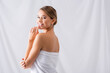 © LIGHTFIELD STUDIOS - cheerful young woman touching lips and smiling on white