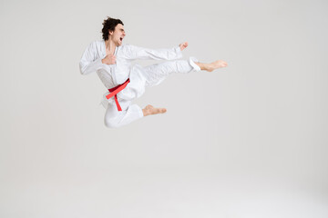 Young caucasian sportsman dressed in kimono practice in karate