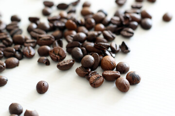 roasted coffee beans on white wooden background