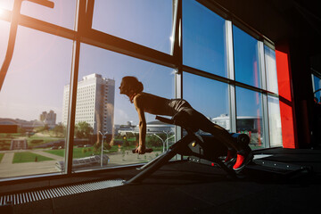 Athletic girl in sportswear performs exercises with barbell, dumbbells. Fitness, healthy lifestyle