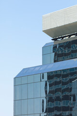 Close-up of an anonymous office building in Madrid, Spain, under the scorching summer sun. A closed work space, sterile for life and built with concrete, steel and glass.