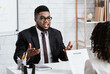 © Prostock-studio - Human resources manager communicating with positive vacancy applicant on employment interview at office