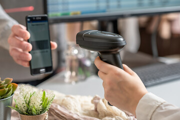 woman cashier scanning qr code from buyer phone using barcode scanner. man buying a gift in a female