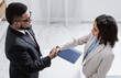 © Prostock-studio - Human resources manager shaking hands with successful vacancy applicant at office, above view. Career fair concept