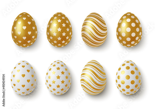 Realistic Gold and white easter eggs with geometric ornaments. Vector © Terina