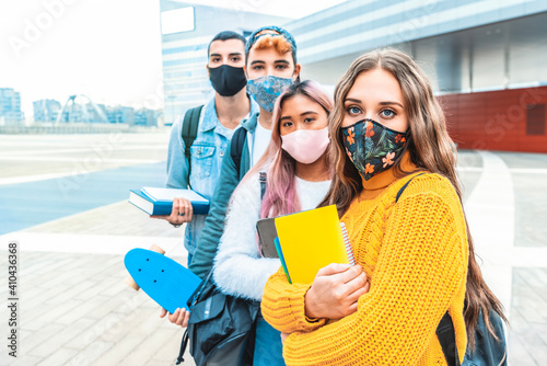 Portrait of a group of students covered by face masks. New normal lifestyle concept with young people going to school at corona virus pandemic.