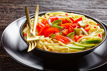 Wall Mural - pasta with avocado, tomatoes and lime, top view