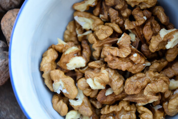 Walnuts harvest on vintage metal background. Walnut kernels from village garden. Organic autumn nuts harvest.