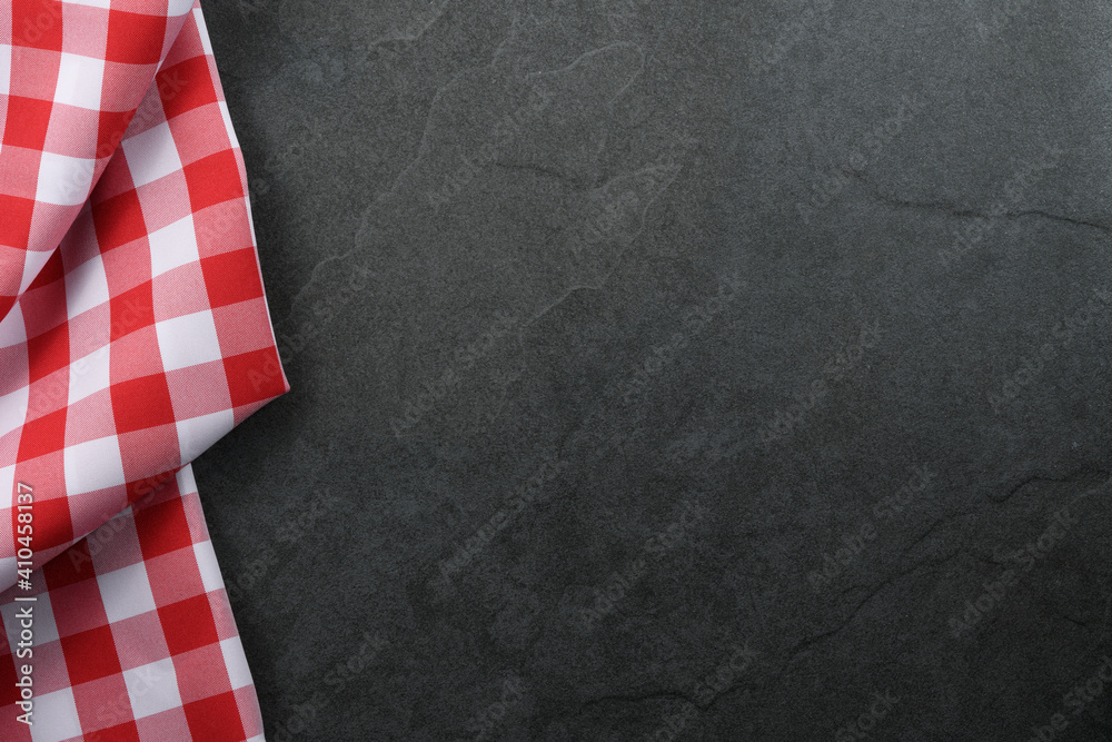 Obraz na płótnie Classic italian cooking background - red checkered tablecloth on a vintage black stone kitchen countertop with copy space w salonie