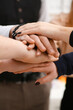 © H_Ko - Group of people in suits crossed hands in pile for win closeup. White collar leadership high five cooperation initiative achievement corporate life style friendship deal heap stack concept