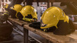 Heavy used fire fighting helmet. Yellow helmets on bench