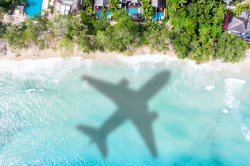 Wall Mural - Travel traveling vacation sea symbolic picture airplane flying Seychelles beach water