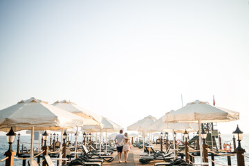 A loving couple is resting at the sea in Turkey. Man and woman on the pier. Sea tour. Honeymoon. Couple on a honeymoon trip. A beautiful couple travels the world. Happy couple on vacation.