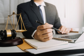 Business and lawyers discussing contract papers with brass scale on desk in office. Law, legal services, advice, justice and law concept picture with film grain effect