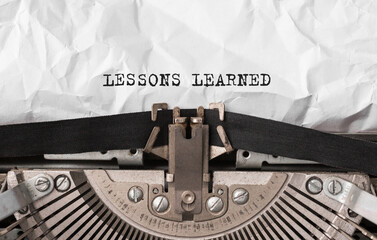 Aufkleber - Text LESSONS LEARNED typed on retro typewriter