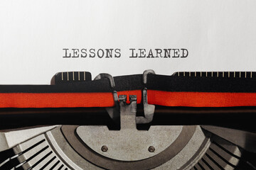 Aufkleber - Text LESSONS LEARNED typed on retro typewriter