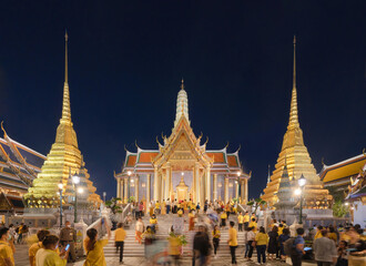 Golden pagoda at Temple of the Emerald Buddha in Bangkok, Thailand. Wat Phra Kaew and Grand palace in old town, urban city. Buddhist temple, Thai architecture. A tourist attraction at night.