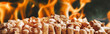 Wood pellets for heating industrial boiler houses with bio fuel in fire. Composite mixed media banner image of woody biomass close-up against the background of blazing flames. Modern energy concept