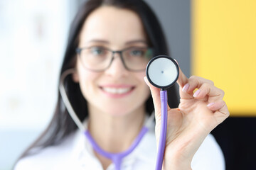 Sticker - Female doctor holding stethoscope in clinic closeup