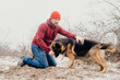 © vitleo - Owner man having fun with best friend german shepherd.