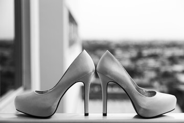 Sticker - Grayscale shot of high heels by the window