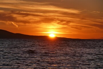 Wall Mural - Orange sunset in the sea and reflection