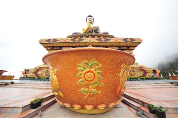 Sticker - Water bowl in the background of the Buddha statue in Tathagata Tsal (Buddha park), Sikkim, India