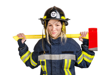 Young brave woman in uniform and hardhat of firefighter with axe on shoulders looking at camera on white background. 