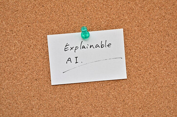 Poster - A piece of paper labeled Explainable AI is pinned to the corkboard.