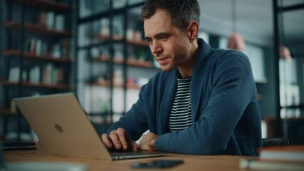 Aufkleber - Handsome Caucasian Man Working on Laptop Computer while Sitting Behind Desk in Cozy Living Room. Freelancer Working From Home. Browsing Internet, Using Social Networks, Having Fun in Flat.