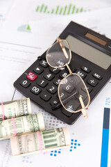 Wall Mural - Calculator, dollar bill and a pair of glasses on financial materials