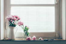 Pastel Pink Flowers On A Vintage Window Sill.