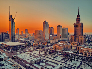 Wall Mural - Beautiful panoramic aerial drone view on Warsaw City Skyscrapers, PKiN, and Varso Tower under construction and 19th-century tenement houses during the January sunset, Warsaw, Poland.