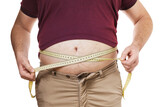 Fototapeta  - Overweight man measures his waist with a measuring tape, isolated on white background. Concept on the topic of excess weight