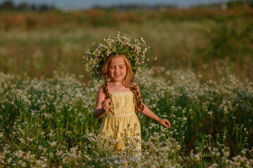 little girl in the field with a wreath on her head walking summer