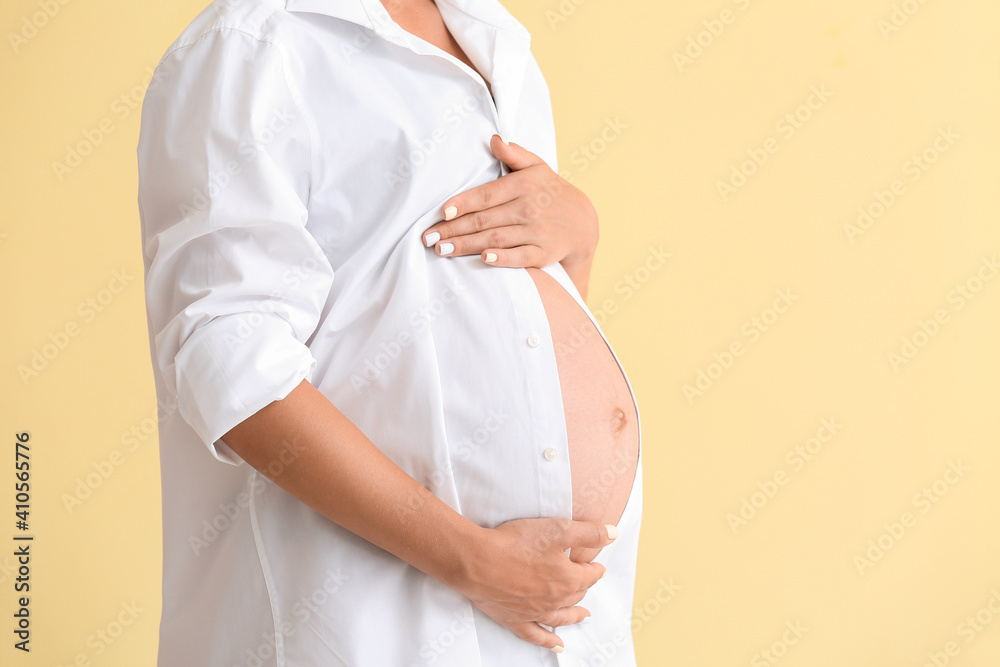 Beautiful pregnant woman on color background