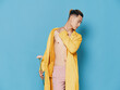 © SHOTPRIME STUDIO - fashionable korean man in an unbuttoned coat a flower in his hand and a haircut on his head