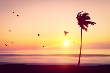 Wall Mural - silhouette palm tree at tropical beach with birds flying on sunset sky abstract background. nature e