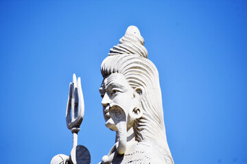 Sticker - Side view of the statue of Lord Shiva against a blue sky