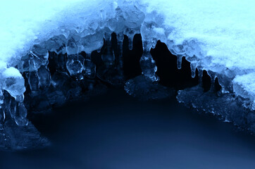 clean ice shapes with freezing river stream underneath